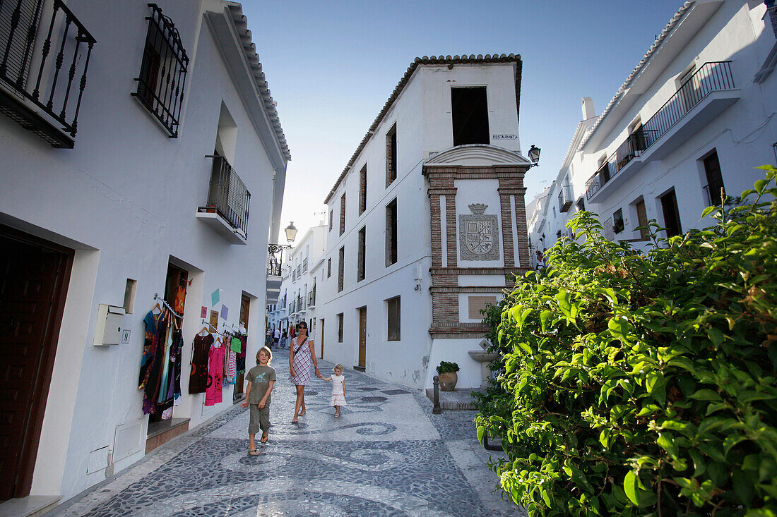 Family walking through Frigiliana, Costa del Sol, Province of Malaga, Andalusia, Spain
