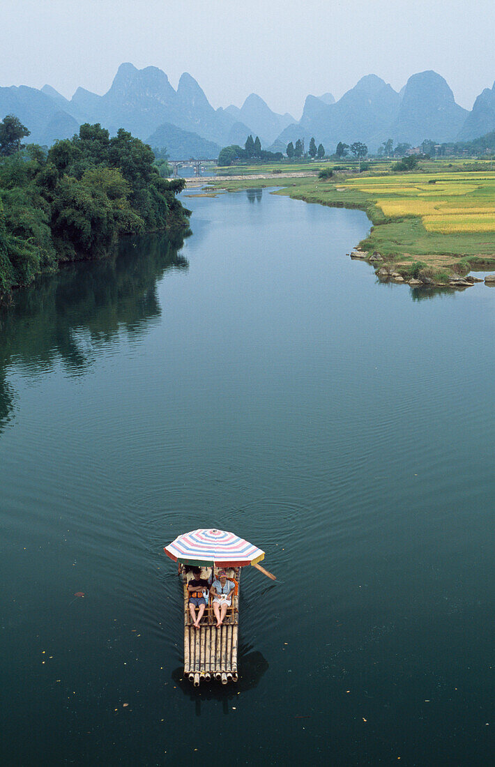 Locals on raft on Ya Long River, Guangxi, China