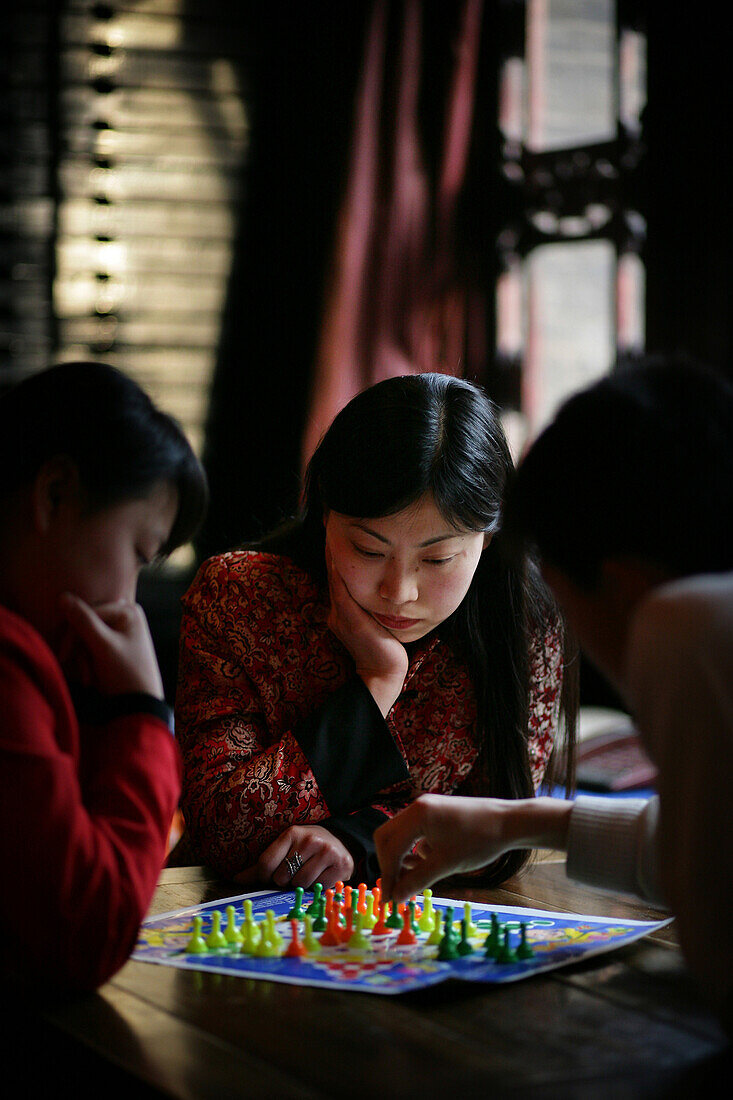 Chinese women playing the board game Chinese checkers in Pingyao, a UNESCO World Heritage Site, Shanxi Province, China