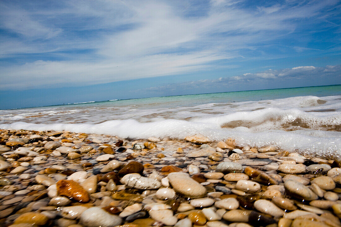Sea washing in onto sandy beach, France
