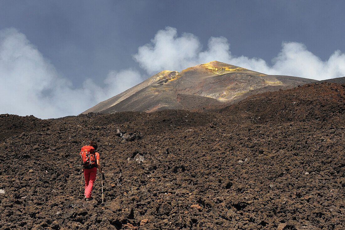 Italy, Sicily, woman walking on lavas under Etna volcano