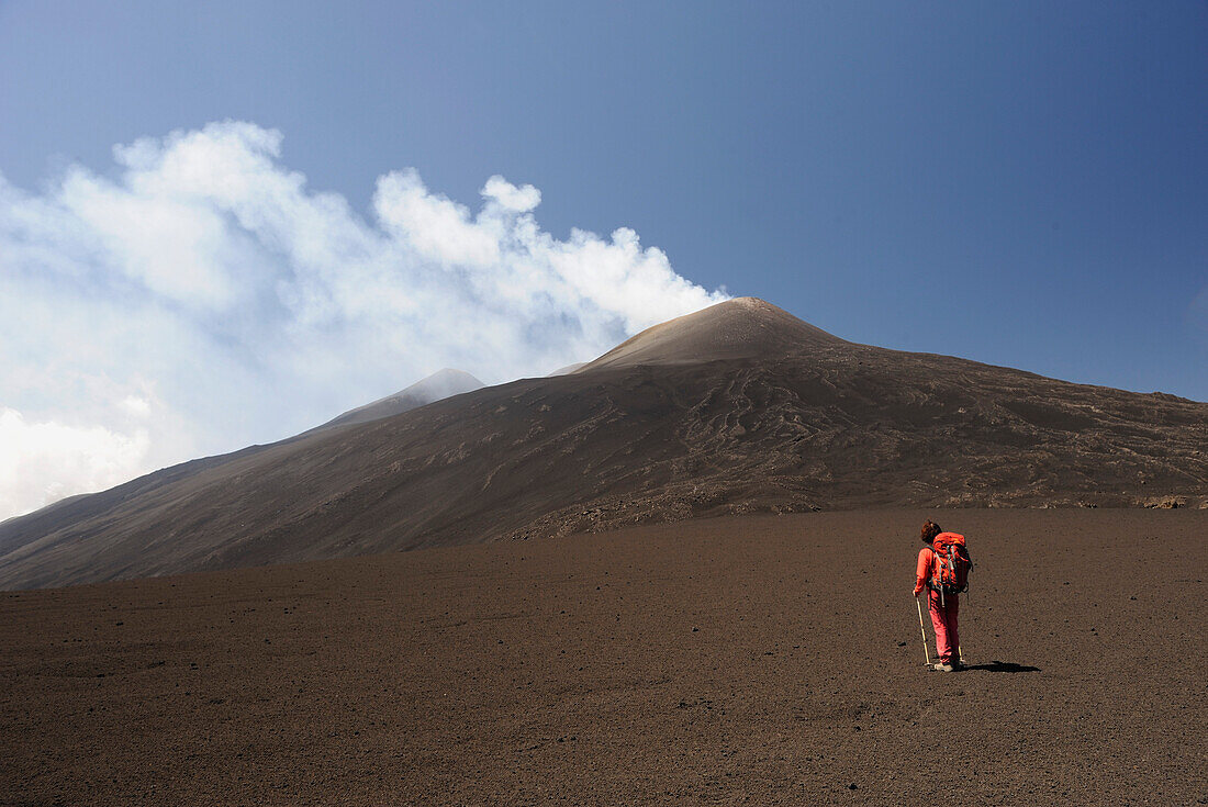 Italy, Sicily, Etna volcano, woman walking up the north slope