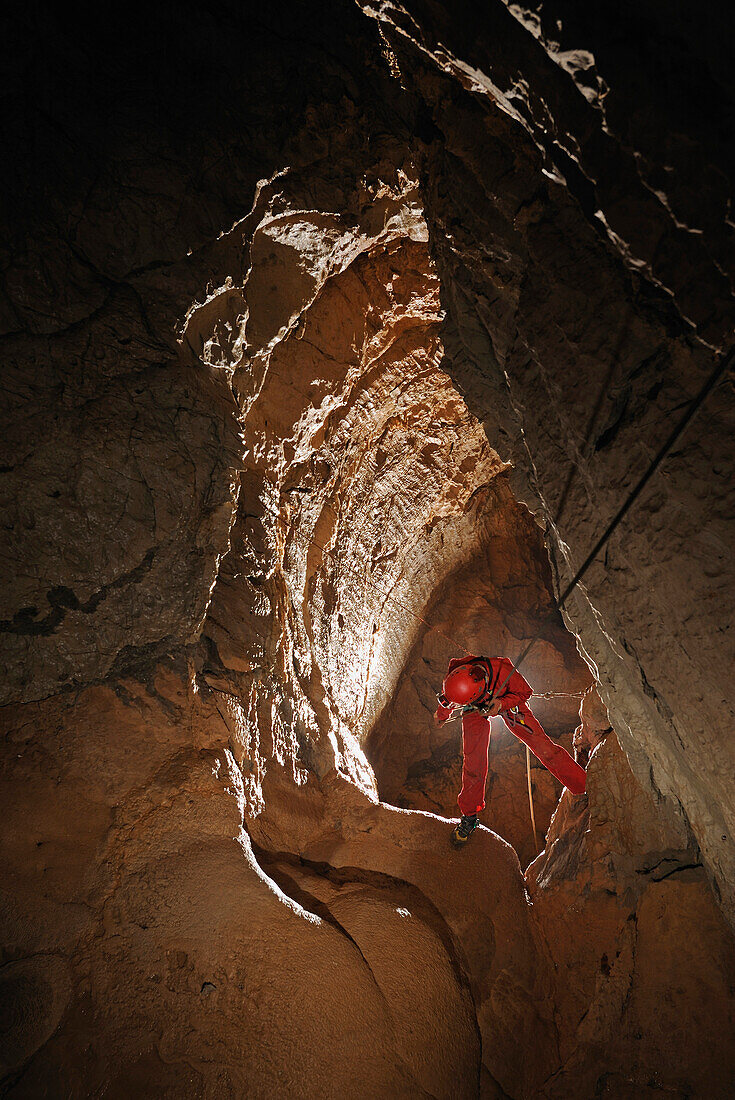 Speleology, caving, descent of a pit with descender, Aven Clara, Aveyron (France)