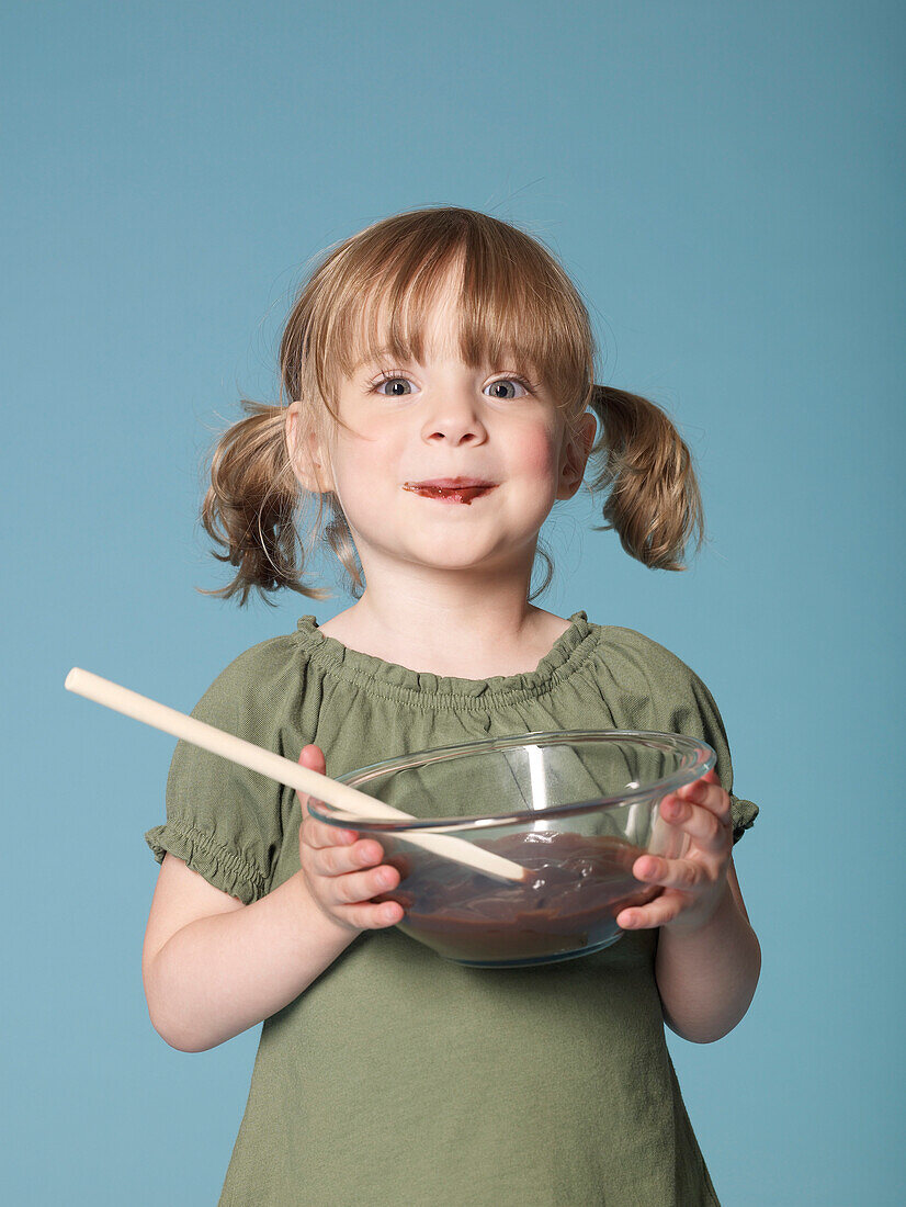 Little girl eating chocolate