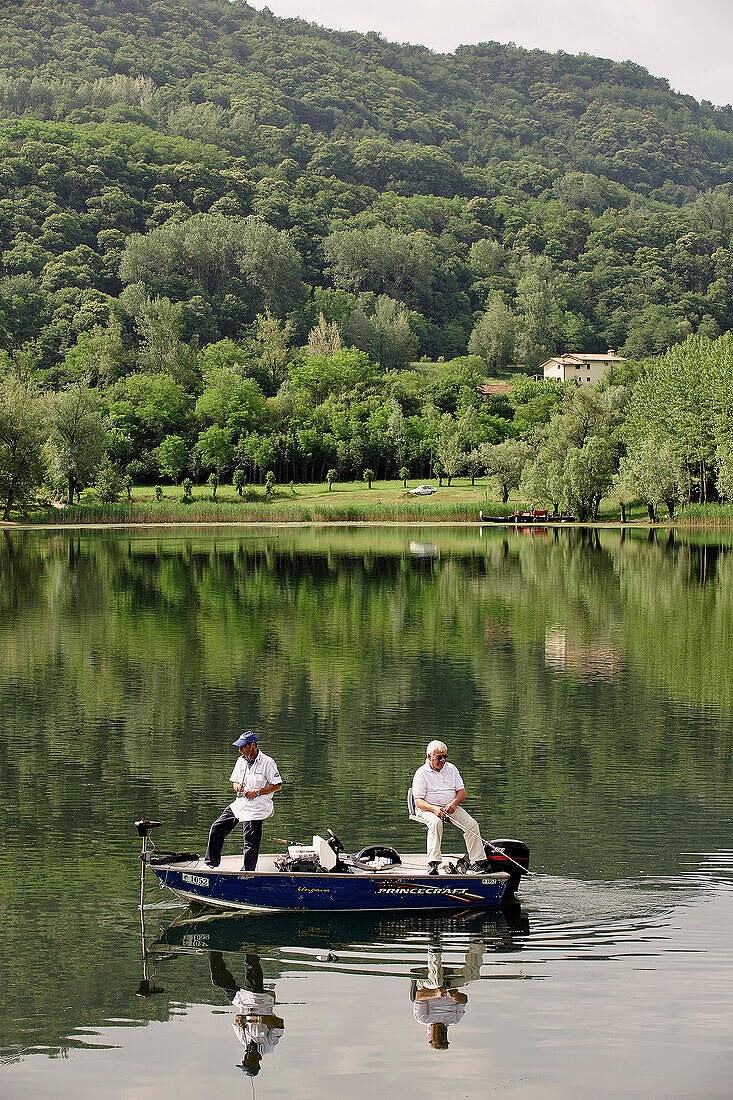 Italy, Veneto, near Vittorio Veneto, fishermen on a lake