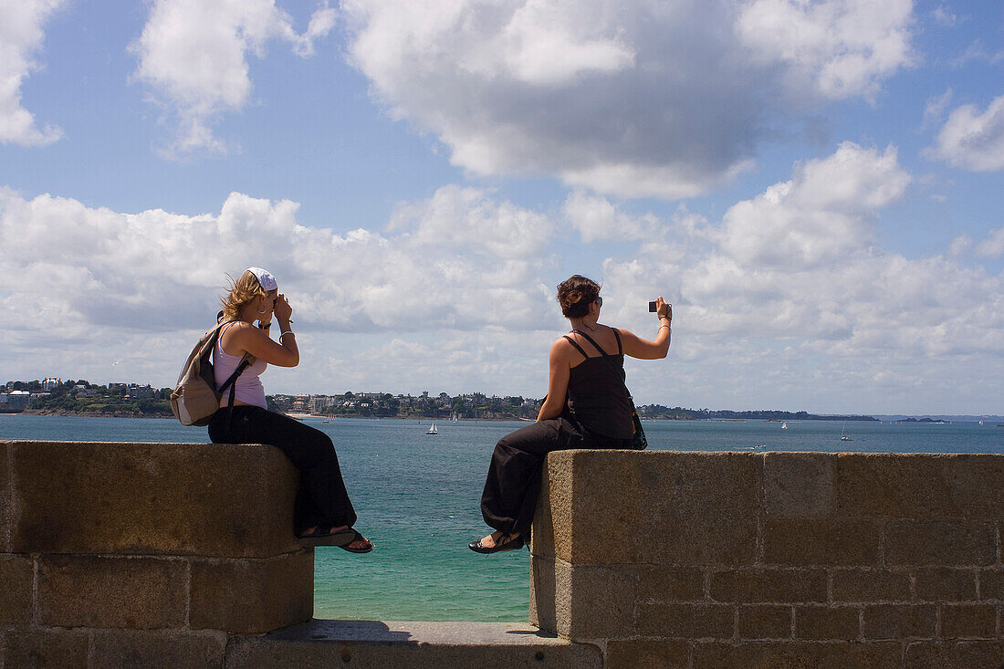 France, Brittany, Saint Malo, women photographing the sea