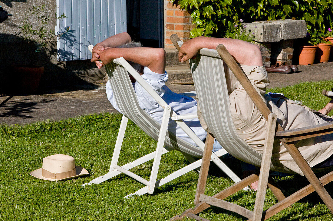 2 men relaxing in deck chairs