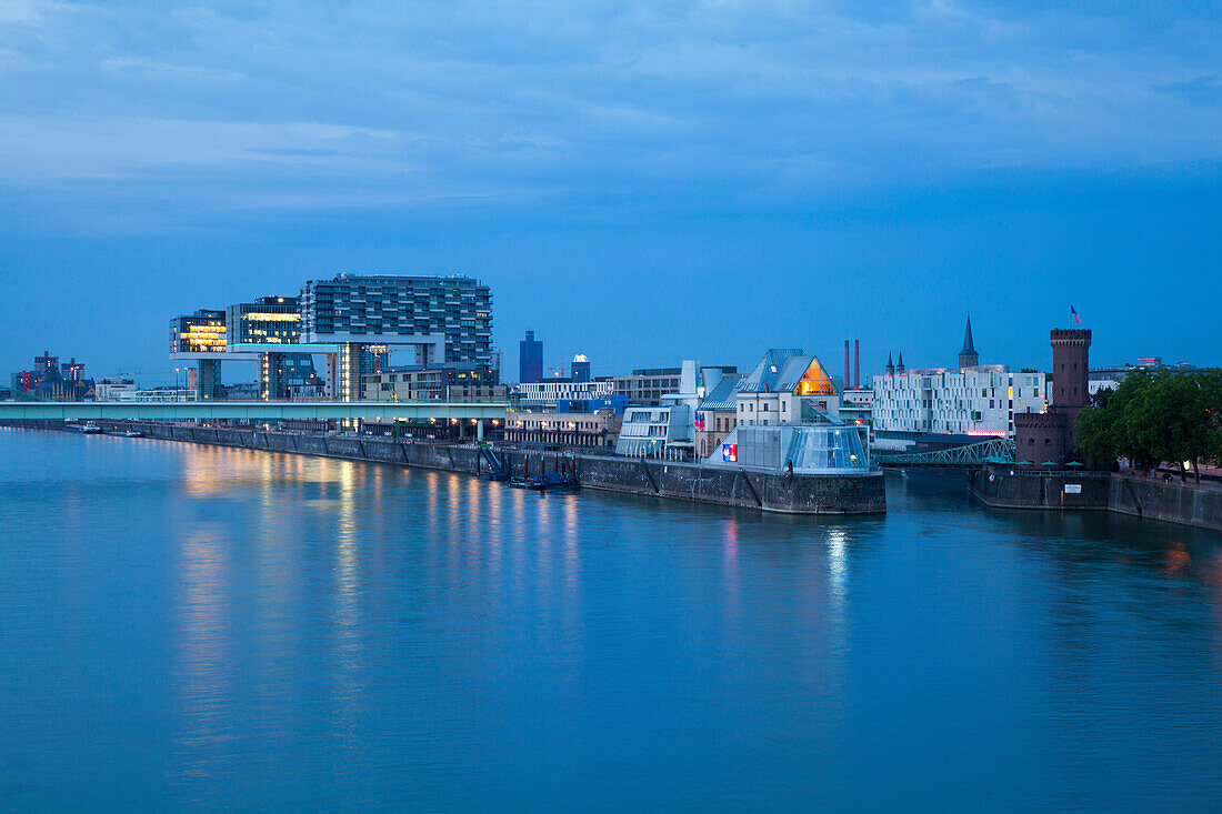 View over the Rhine river to Rheinau harbour, Chocolate museum and Malakoff tower in the evening, Cologne, North Rhine-Westphalia, Germany, Europe
