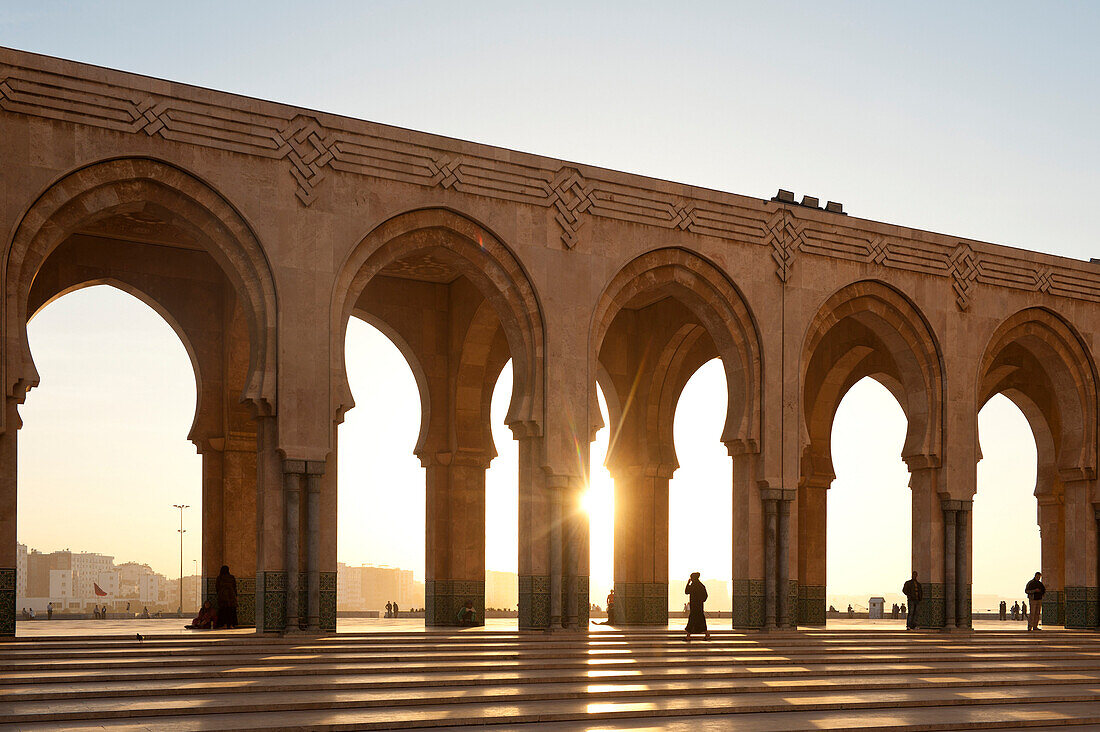 Looking through archways of the Hassan II mosque at dusk, Casablanca, Morocco.