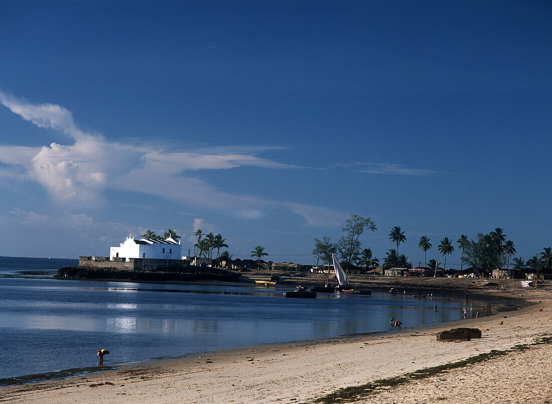 Looking along beach to dhows and church of Santo Antonio, Ilha de Mocambique, Mozambique