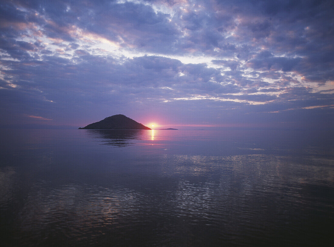 Looking out to small island off Cape Maclear at dusk, Lake Malawi, Malawi