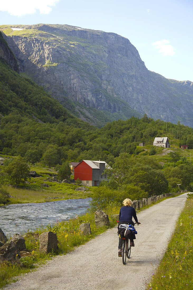 Woman cycling, Flam Valley, Norway