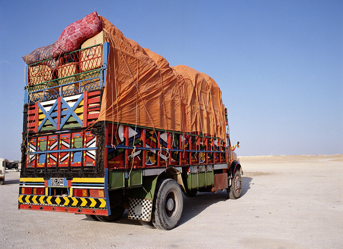 Truck on desert highway, Oman
