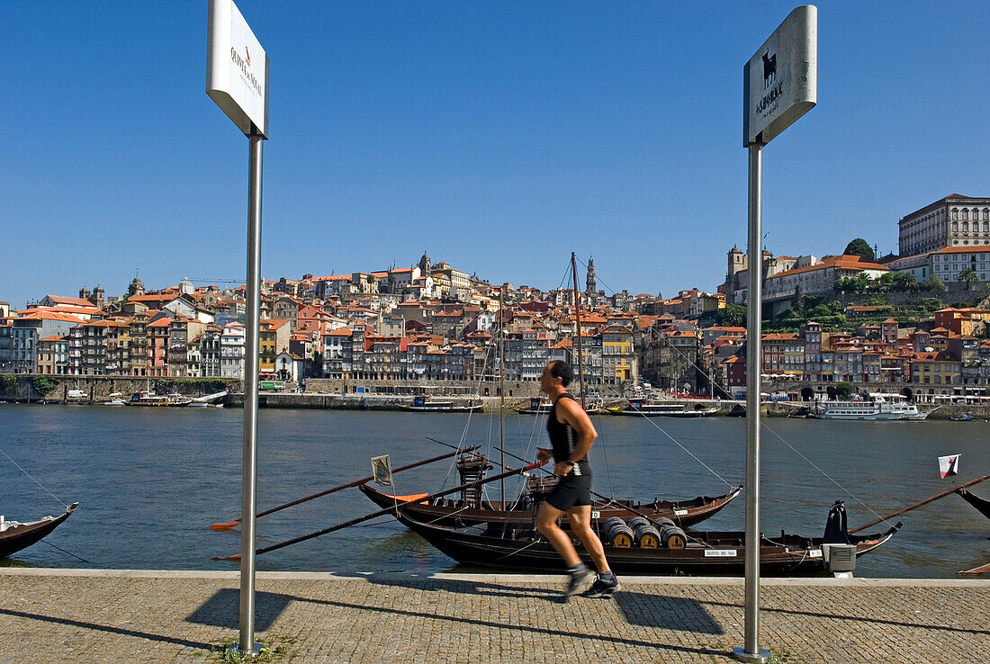 A man jogging along the quayside at Oporto, Portugal
