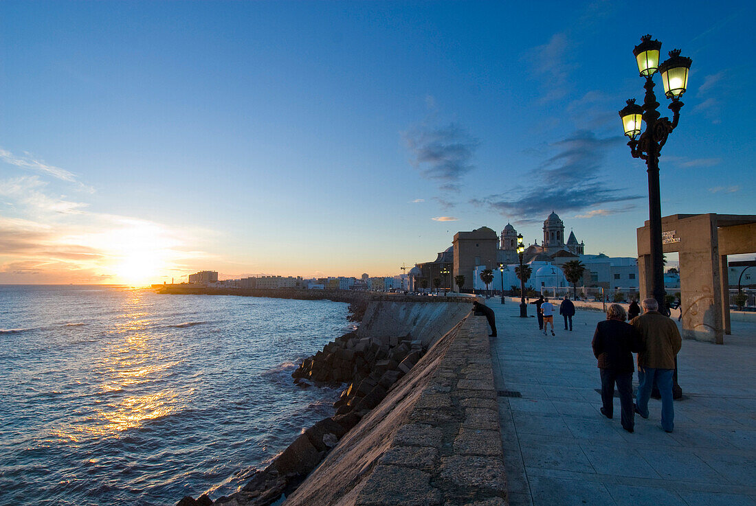 People on promenade at sunset, Cadiz, Andalucia, Spain