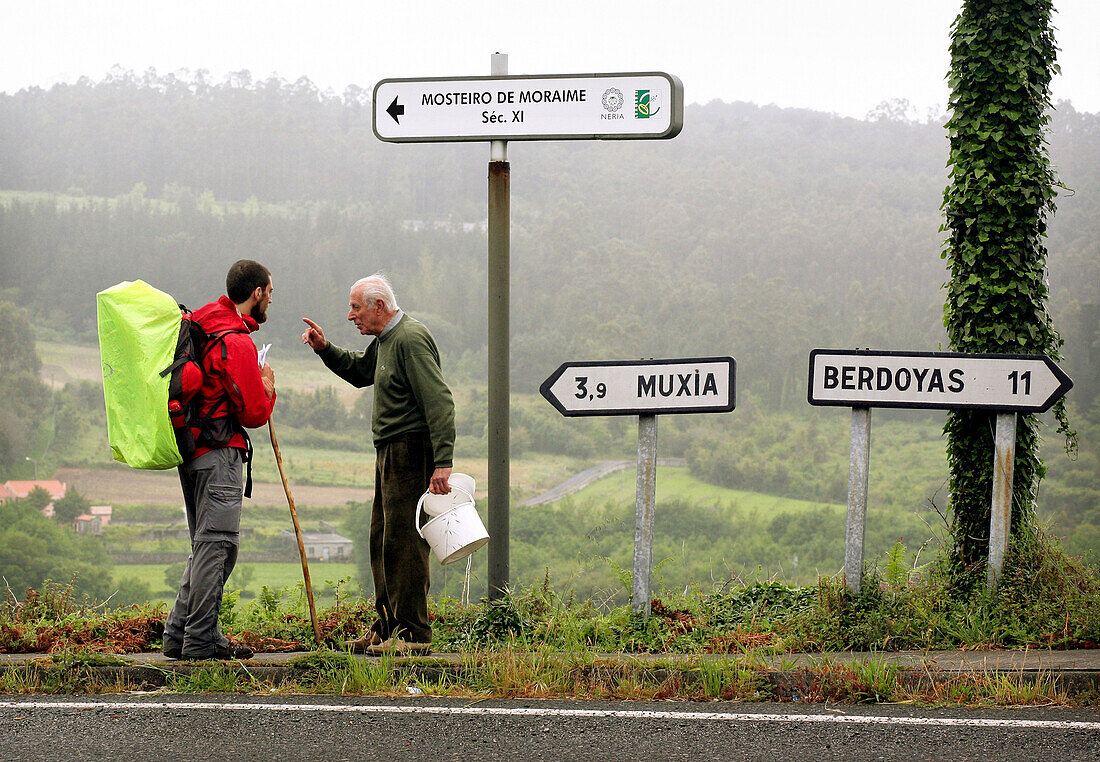 A pilgrim talks to a local, Santiago de Compostela, Galicia, Spain