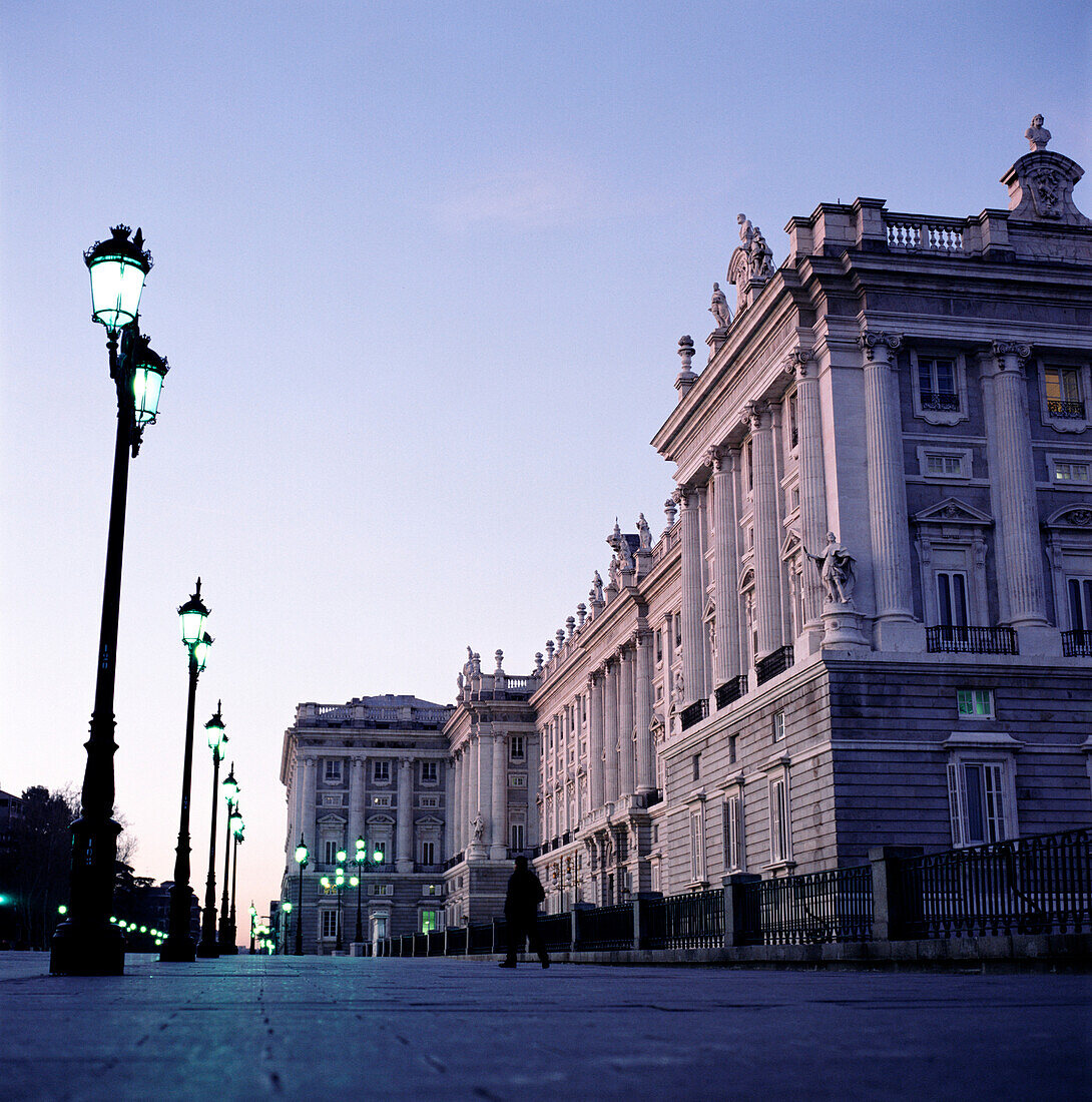 Person walking in-front of Royal Palace at dawn, Madrid, Spain