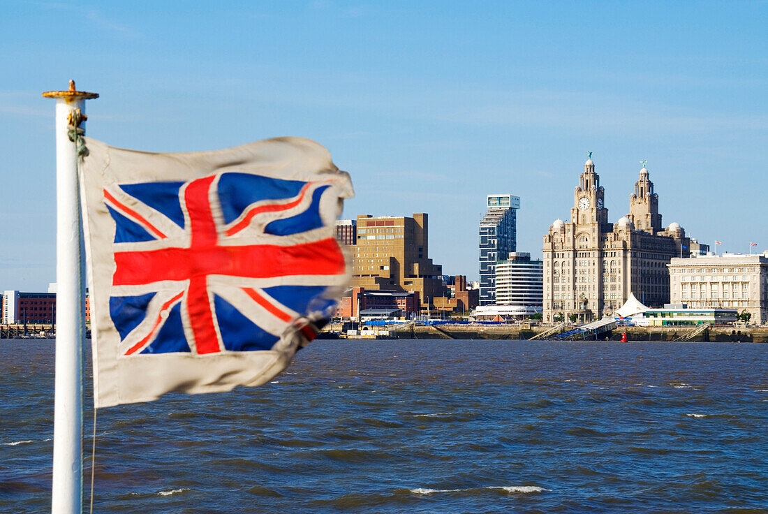 Three Graces in Liverpool skyline with Union Jack flag, Liverpool, England