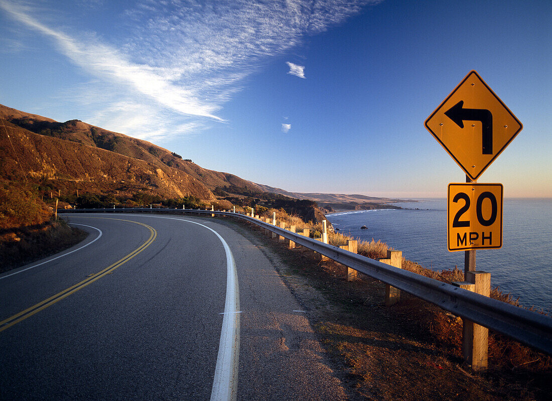 20mph sign on tight corner of Route 1 at dusk, Big Sur, California