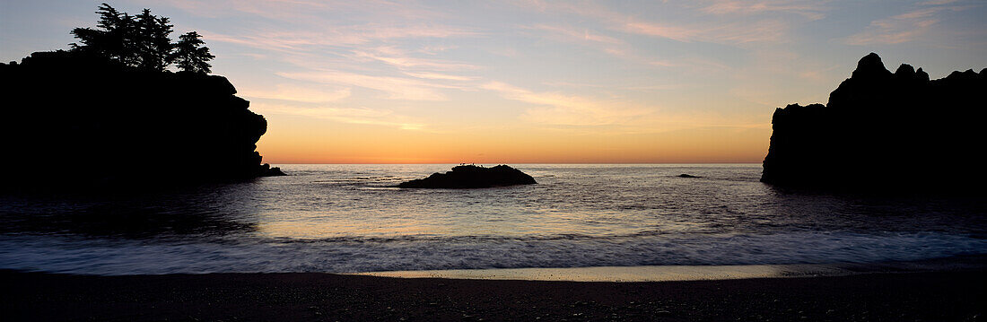 Two cliffs lining beach at sunset, Julia Pfeiffer Burns State Park, Big Sur, California