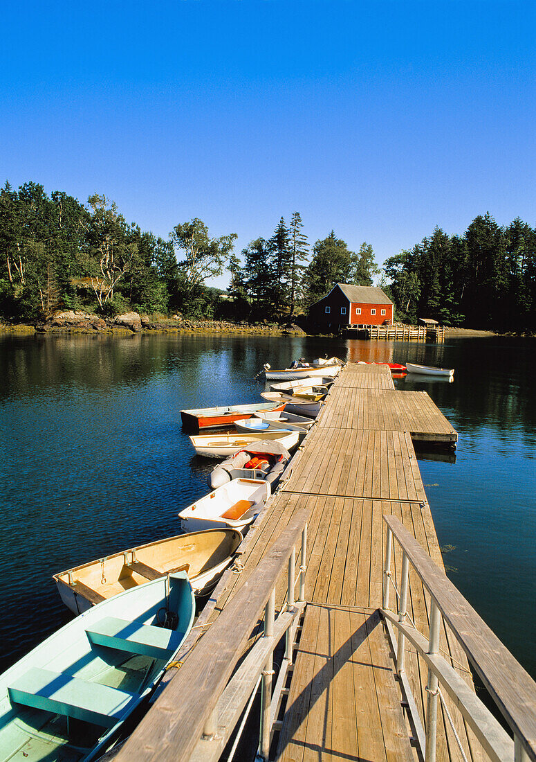 Old wooden pier and boats in harbor, South Brooksville, Maine, USA