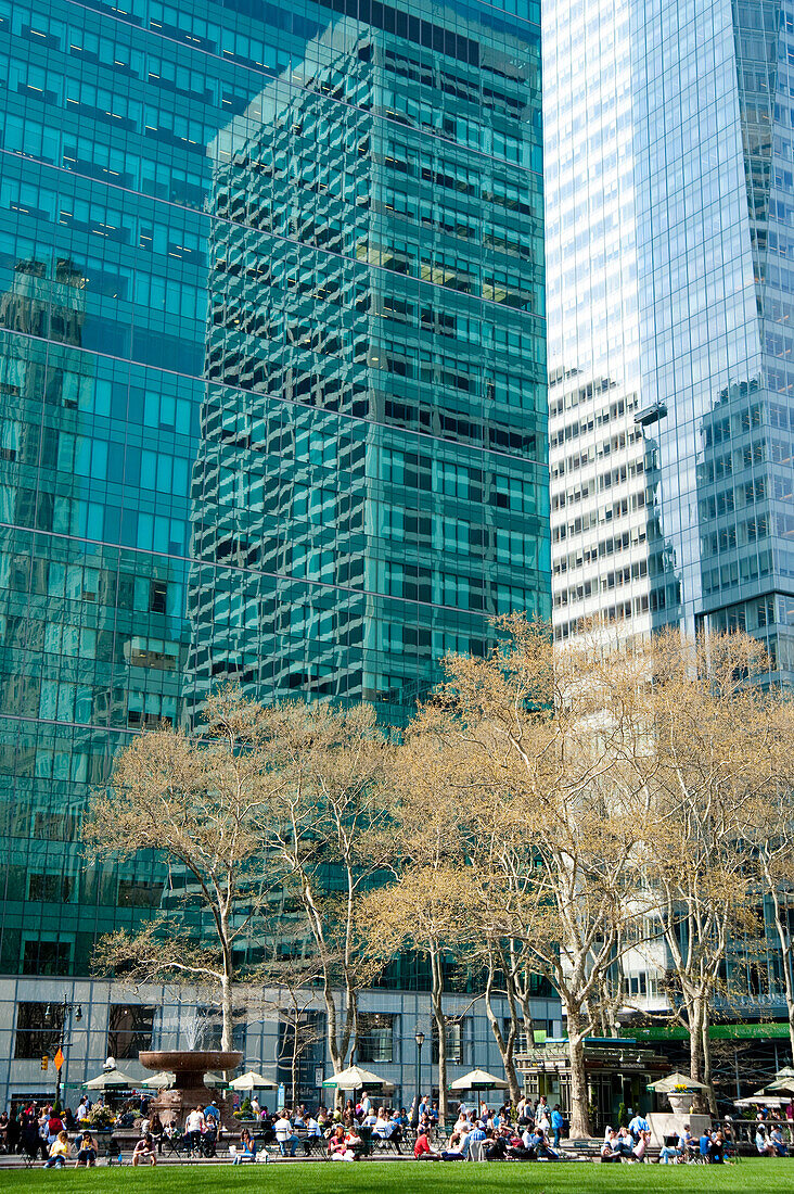Skyscrapers Surrounding Bryant Park And People Enjoying The Sun, Garment District, Manhattan, New York, USA