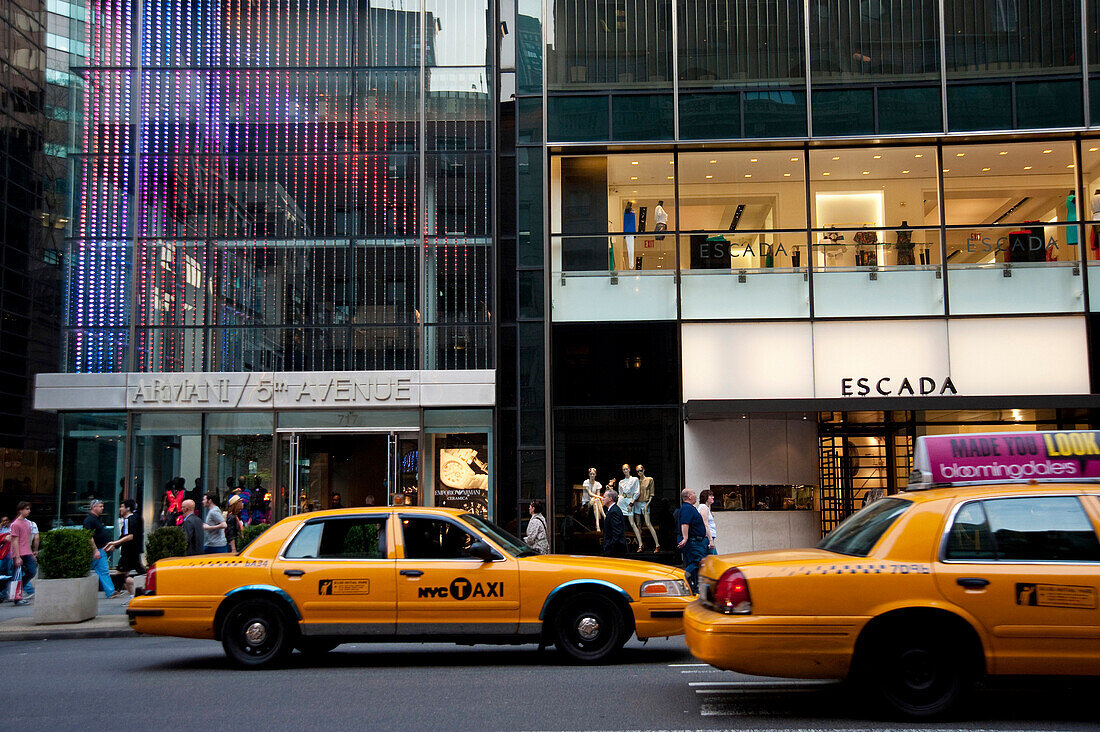 Taxis Passing By Some Designer Shops In 5Th Avenue, Midtown Manhattan, New York, USA