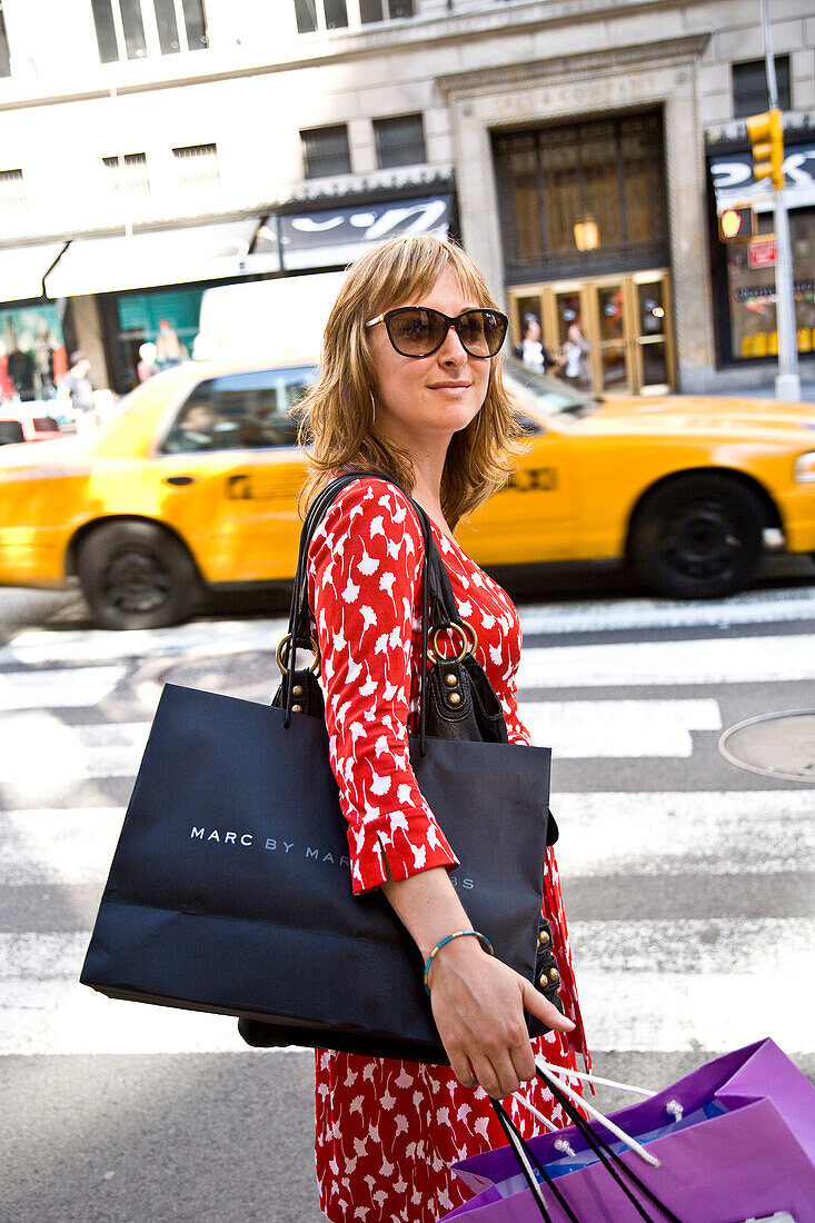 Girl shopping on Fifth Avenue, New York City, USA