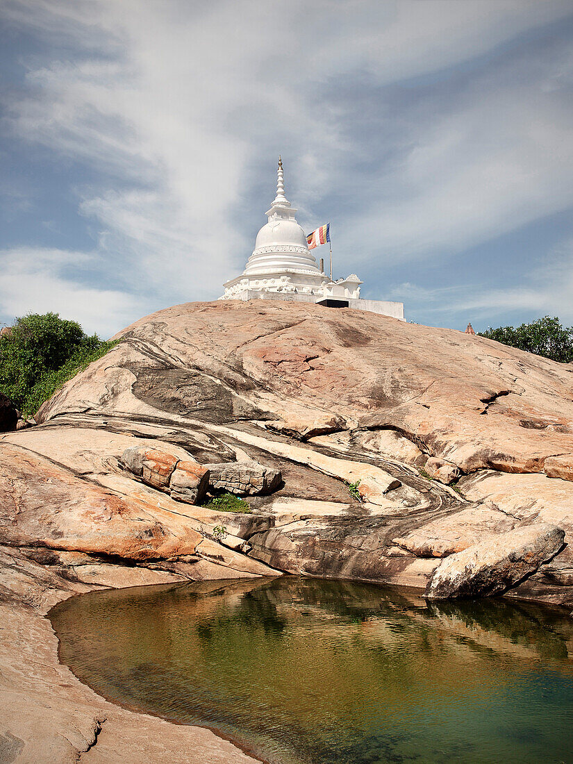 Buddhist stupa and flag on a rock, Kirinda, Sri Lanka