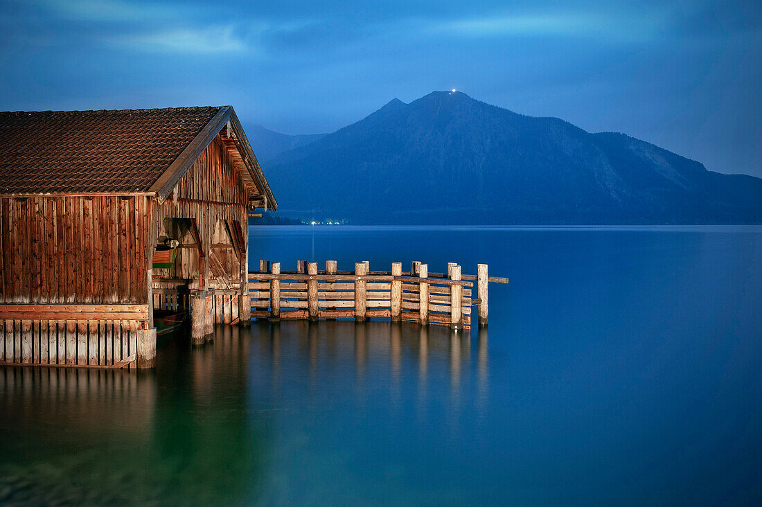 Boat hut at Lake Walchensee in the evening light with view of the Herzogstand, Kochel am See, Bad Toelz, Bavaria, Germany