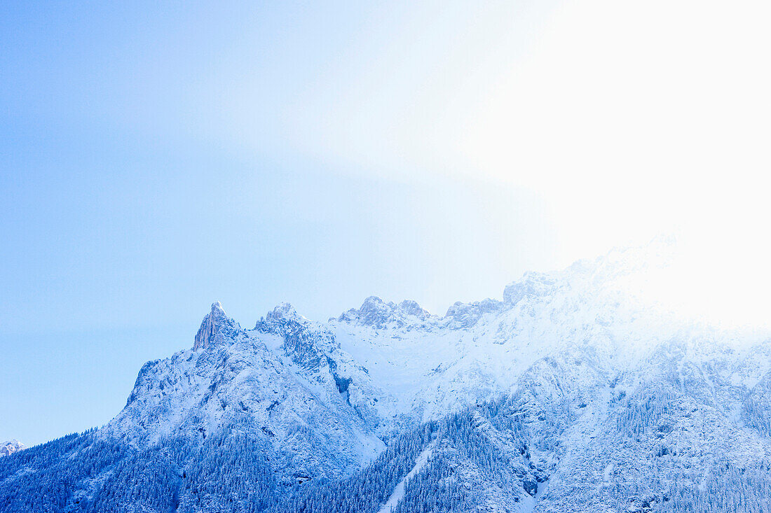 Snow covered mountain and peak at sunrise above the Westliche Karwendelspitze, Karwendel National Park, Mittenwald, Bavaria, Germany