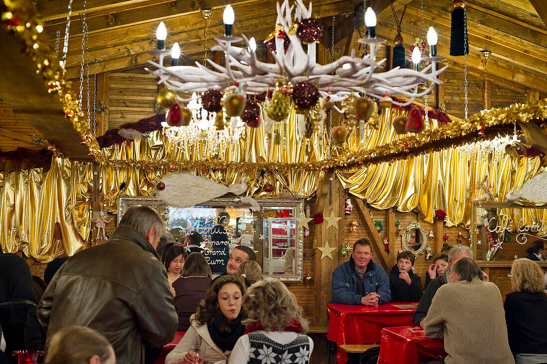 People inside a hut at the Christmas market, Basel, Switzerland