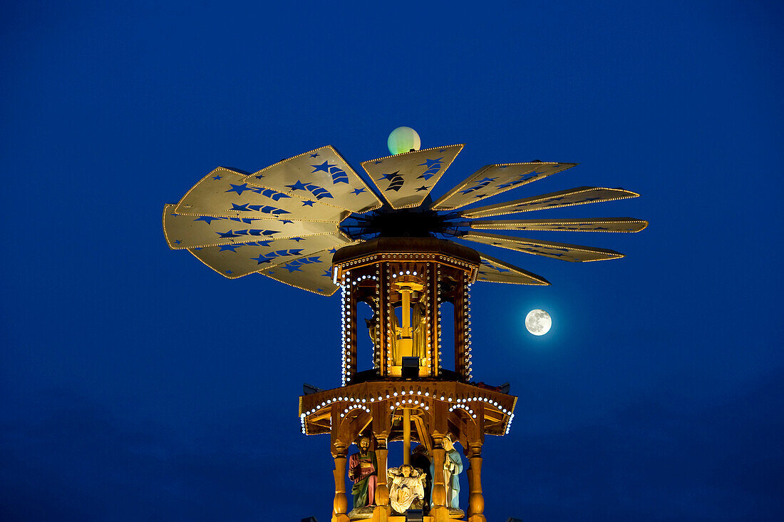 Christmas pyramid with full moon at the Christmas market, Karlsruhe, Baden-Wuerttemberg, Germany