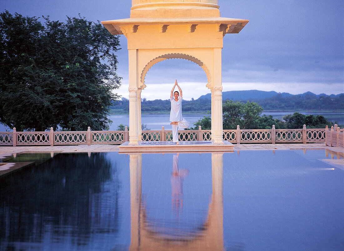 Yoga in the archway of Udaivila, Udaipur, Rajasthan, India