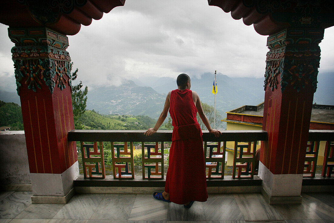 Buddhist monk on balcony, Rumtek Monastery, Rumtek, Near Gangtok, Sikkim, India