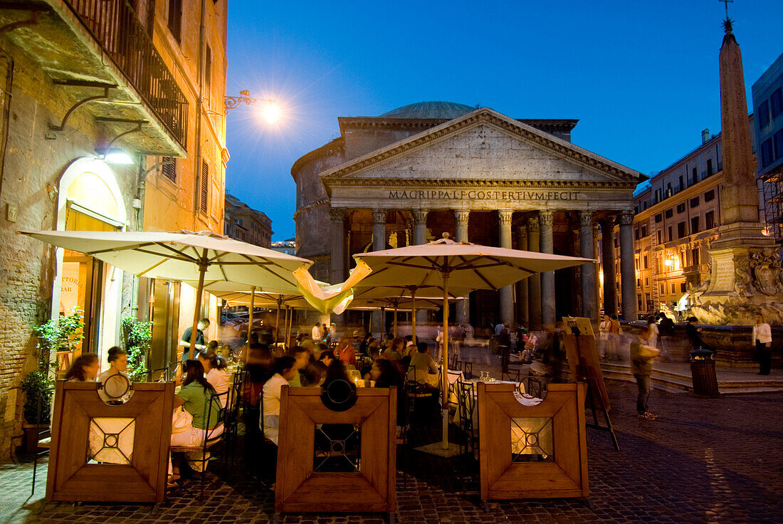 People in outdoor cafe in front of Pantheon at dusk, Rome, Italy