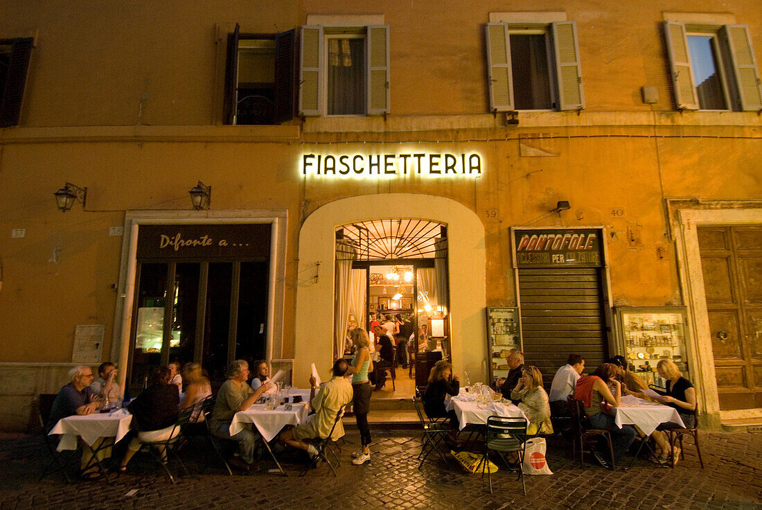 People dining in outdoor restaurant, Rome, Italy