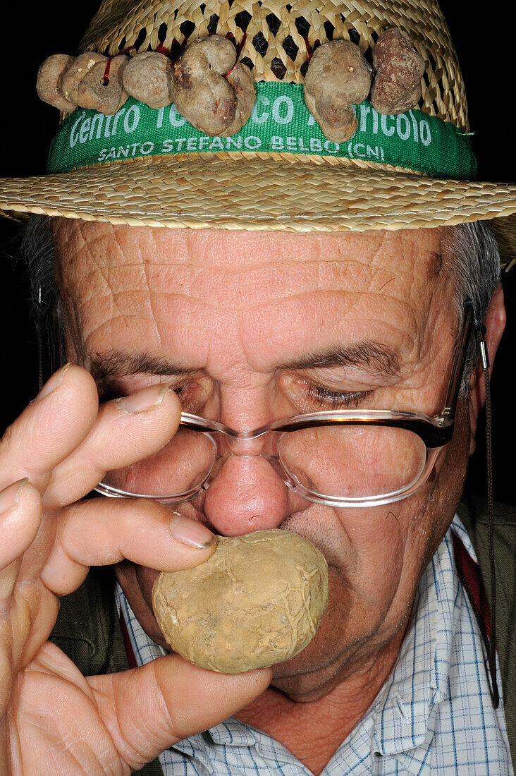 Truffle hunter smells truffle, Alba Truffle Festival, Piedmont, Italy