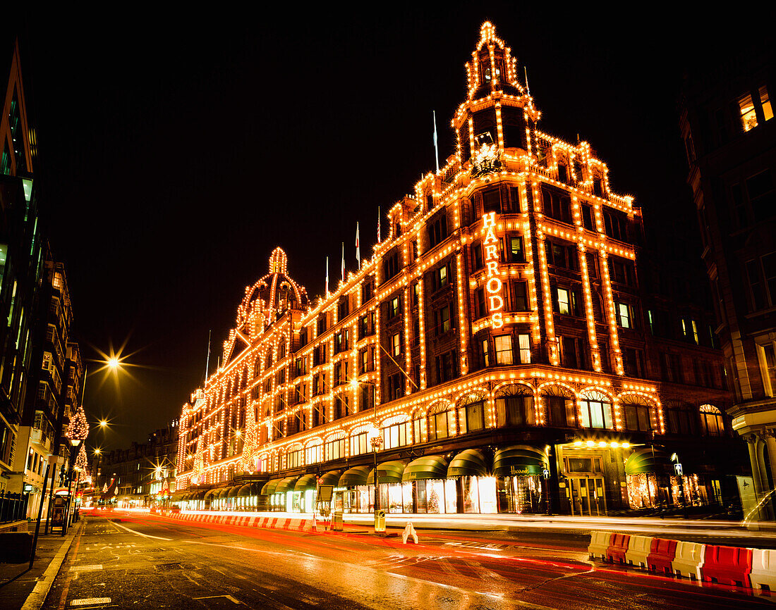 Harrods with Christmas lights at night, London, UK