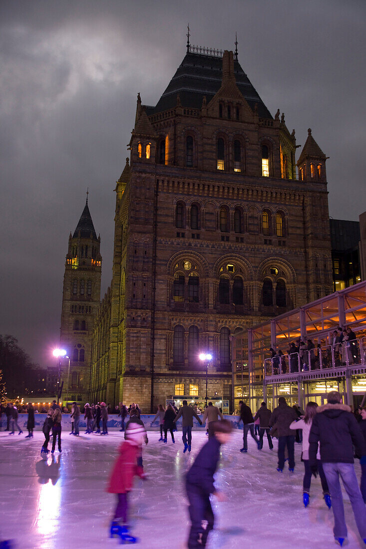 People ice skating outside Natural History Museum, London, England