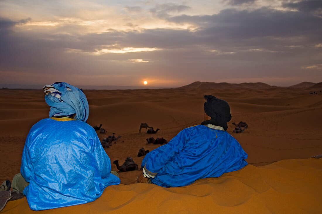 Berber men watching sunrise, Erg Chebbi, Sahara Desert, Merzouga, Morocco