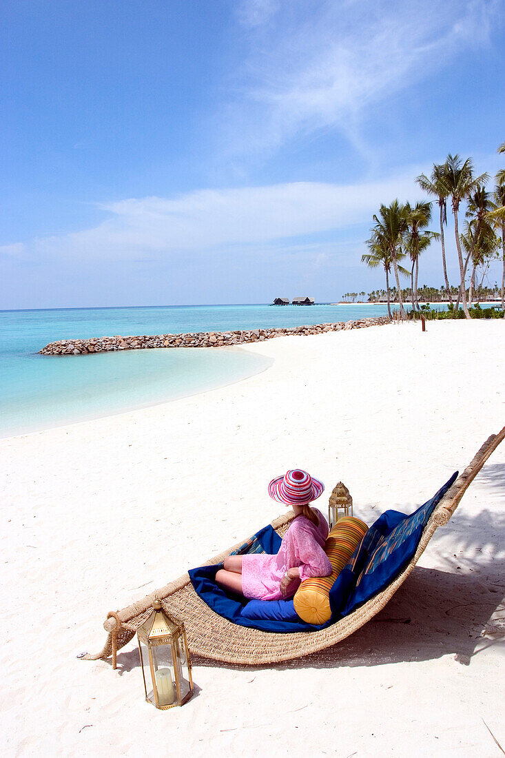Woman on beach chair, Maldives