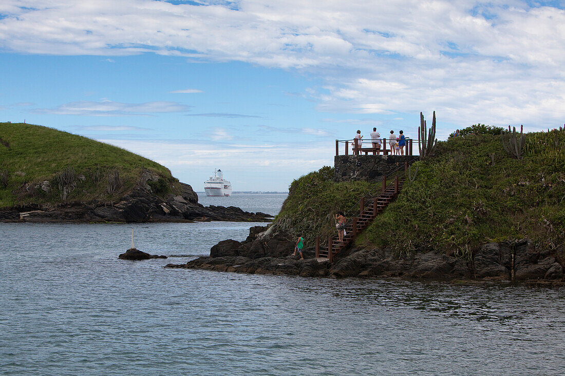 People on coastal platform with cruise ship MS Deutschland, Reederei Peter Deilmann, in distance, Cabo Frio, Rio de Janeiro, Brazil, South America