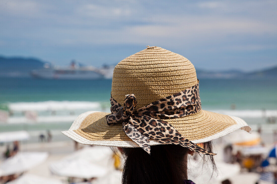Woman with sun hat on Praia do Forte beach, Cabo Frio, Rio de Janeiro, Brazil, South America