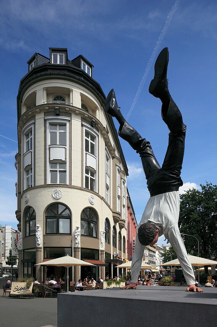 Germany, Wuppertal, Wupper, Bergisches Land, North Rhine-Westphalia, NRW, D-Wuppertal-Elberfeld, Sasse House, business premises, sidewalk cafe, sculpture ´A new successful day´ by Guillaume Bijl, businessman does a handstand