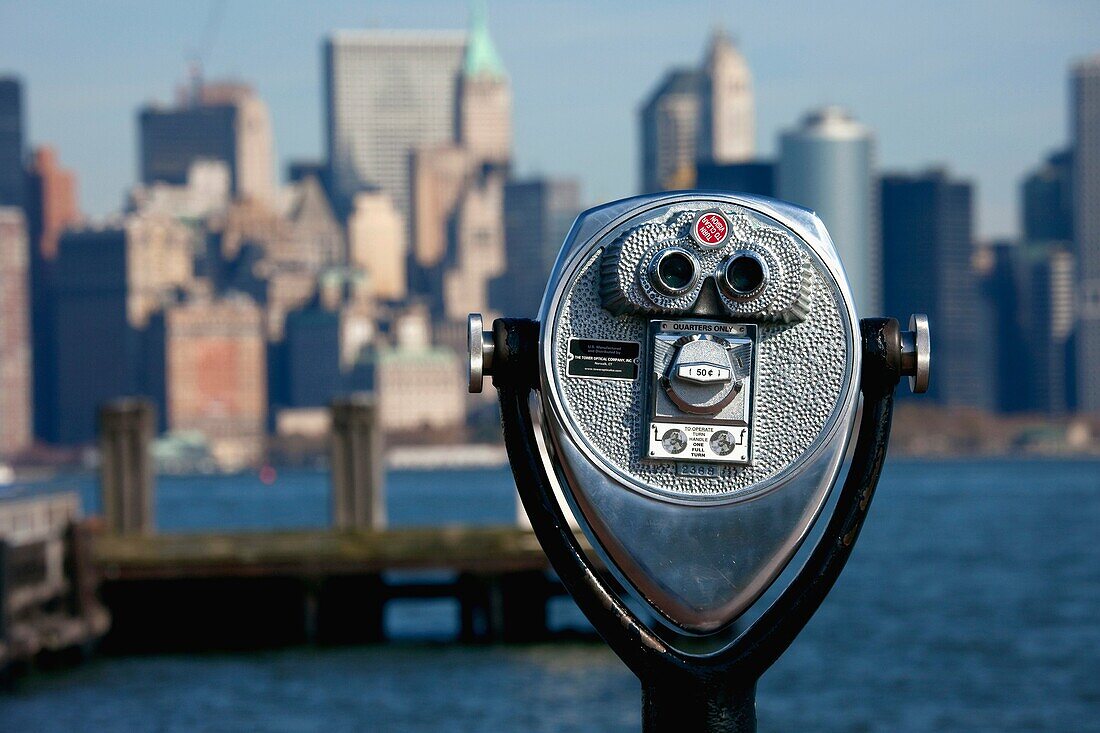 Coin-operated binocular viewer installed at the Statue of Liberty overviewing Lower Manhattan, New York, USA