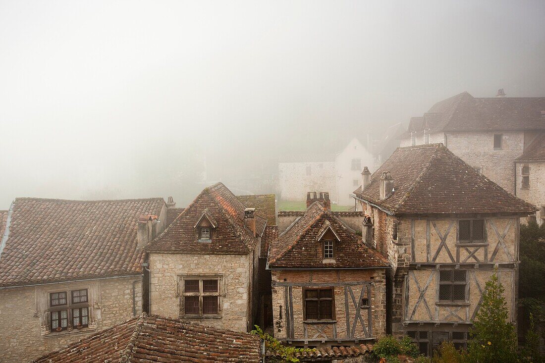 France, Midi-Pyrenees Region, Lot Department, St-Cirq-Lapopie, town overview in fog