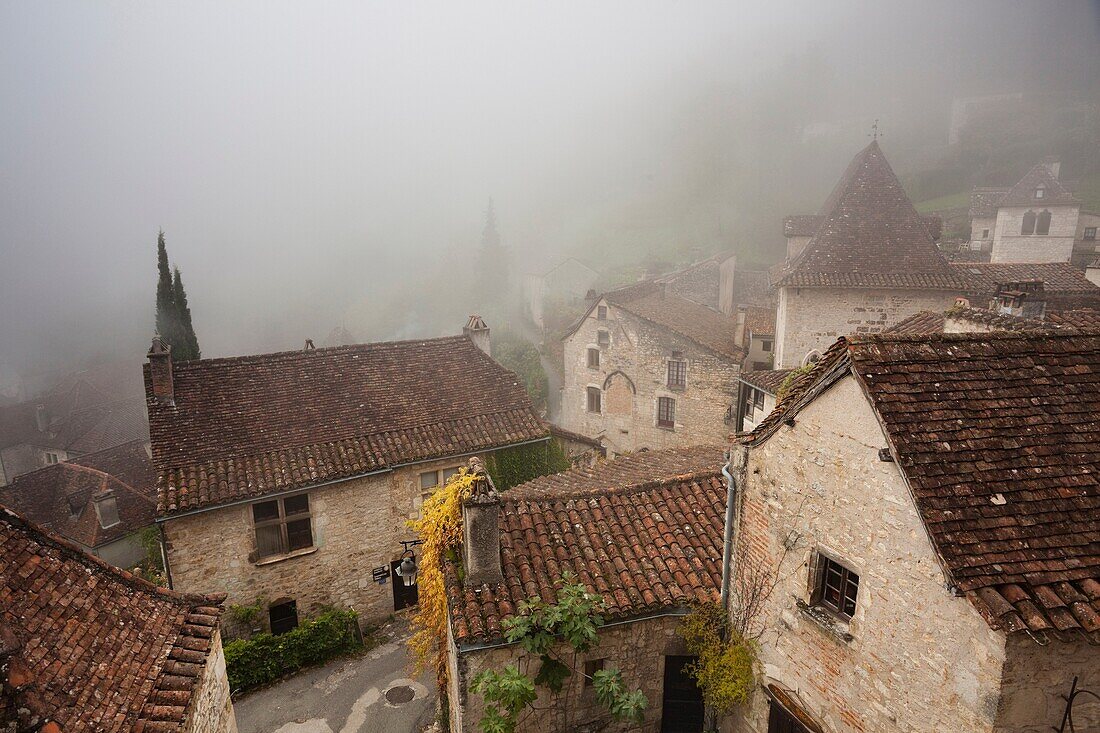 France, Midi-Pyrenees Region, Lot Department, St-Cirq-Lapopie, town overview in fog