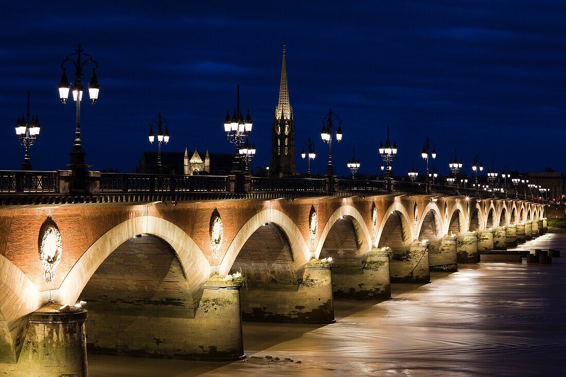 France, Aquitaine Region, Gironde Department, Bordeaux, Pont de Pierre bridge, Eglise St-Michel and Garonne River, dusk