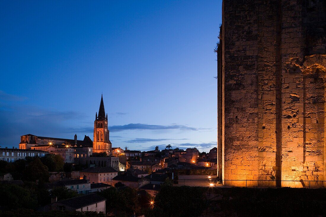 France, Aquitaine Region, Gironde Department, St-Emilion, wine town, town view with Eglise Monolithe church and Chateau du Roy tower, dawn
